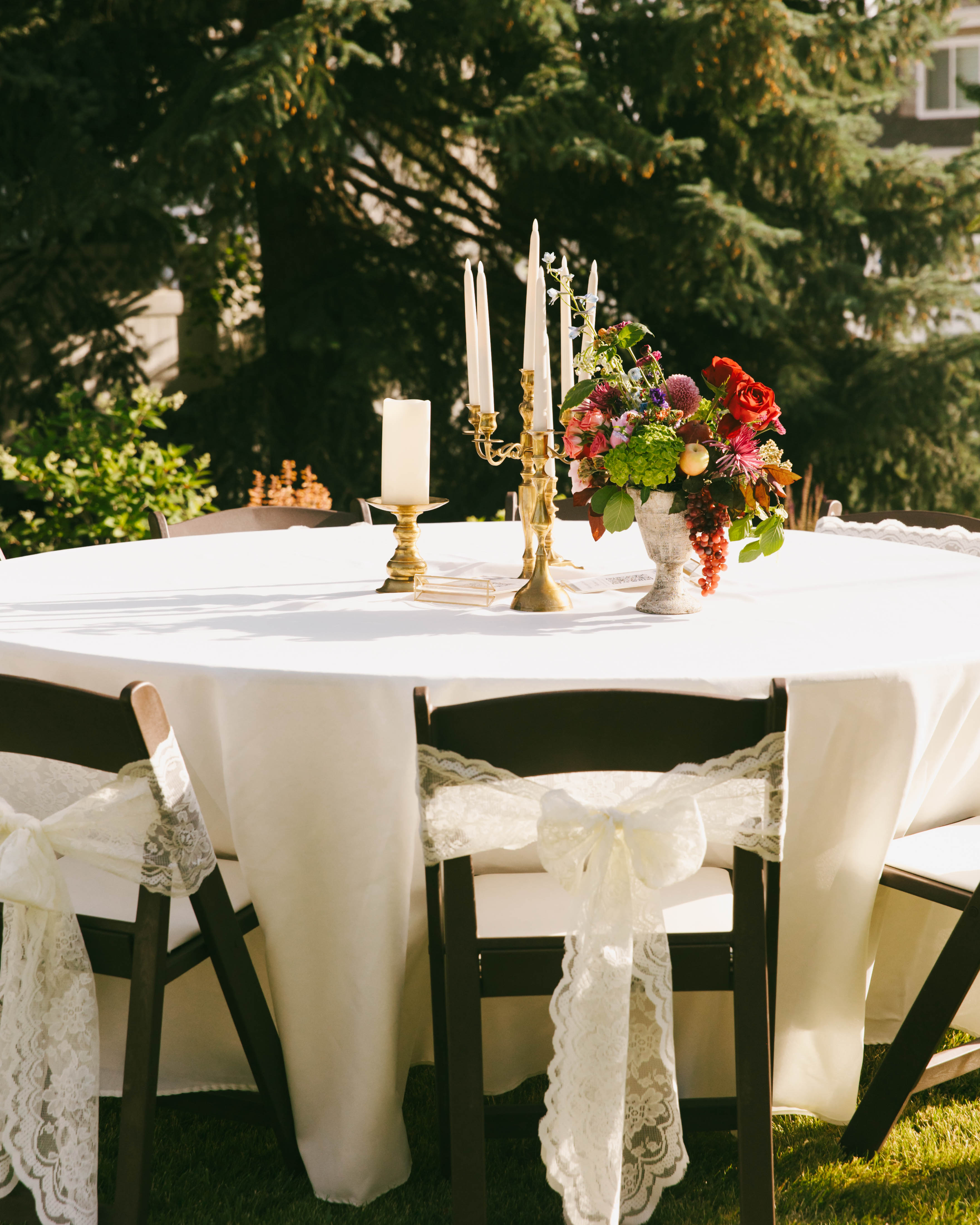 Wedding table with lace bows, candelabra, and floral centerpiece