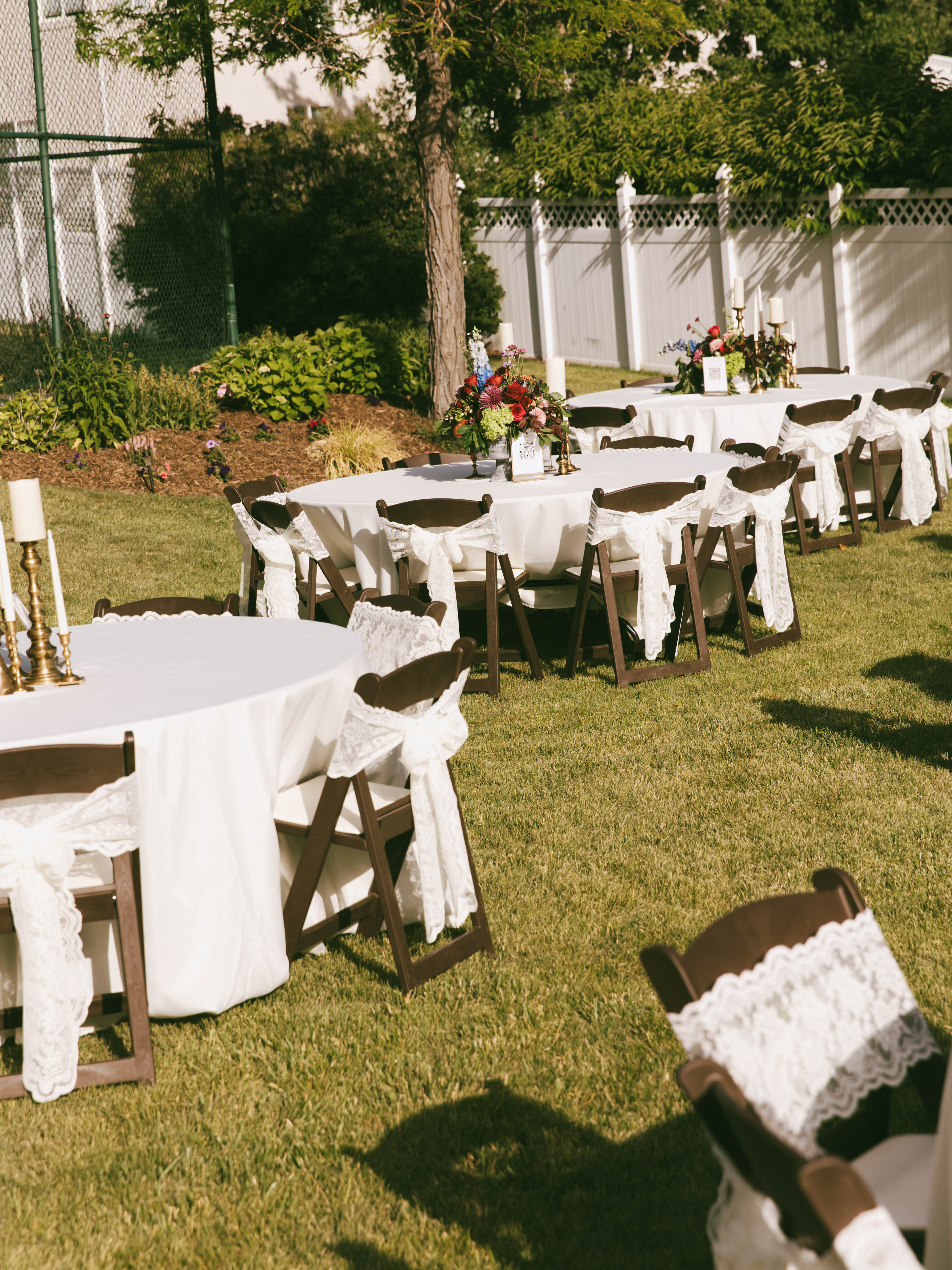 Wide view of decorated wedding table with ivory lace bows